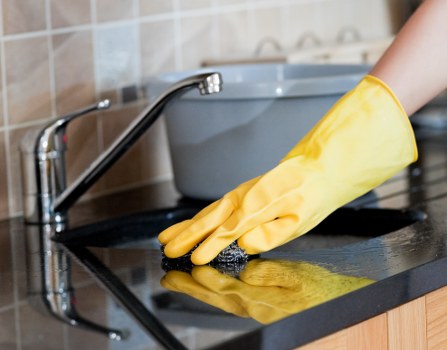 Professional oven cleaner in E15 removing burnt-on grease from a kitchen oven