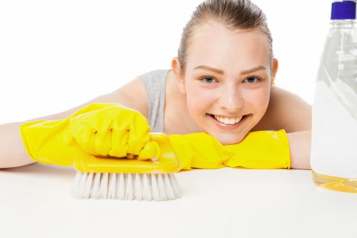 Staff member following carpet cleaning safety procedure